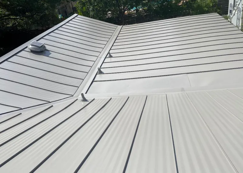 Solar attic fan installed on a metal roof for Roof Ventilation in Joplin